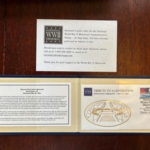 May include: A commemorative stamp and related materials for the National World War II Memorial. The stamp features a gold illustration of the memorial. The text includes "Tribute to a Generation" and "Dedicated May 29, 2004."
