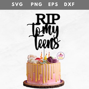May include: A birthday cake with pink frosting and gold drips, topped with a black cake topper that reads "RIP to my teens." The cake is decorated with flowers, macarons, and lit candles. The cake sits on a wooden base.