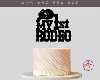 May include: Black and white silhouette of a cowboy hat with a star on top and the text "My 1st Rodeo" on a white cake.