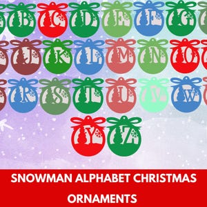 May include: A selection of Christmas ornaments, each with a letter of the alphabet and a snowman silhouette. The ornaments are in various colours, including green, red, blue, and brown, with a decorative bow. The text at the bottom reads "SNOWMAN ALPHABET CHRISTMAS ORNAMENTS."