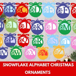May include: A set of 26 colourful Christmas ornaments featuring a snowflake design and a letter of the alphabet. Each ornament is a different colour and has a white snowflake and a white letter in the centre.