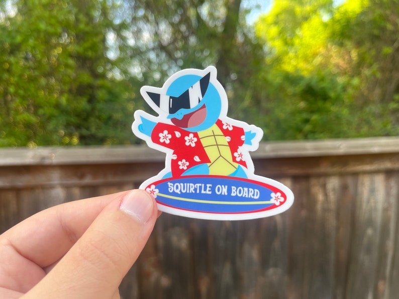 May include: A blue and yellow cartoon Squirtle wearing sunglasses and a red and white Hawaiian shirt is riding a blue surfboard with the text "Squirtle on Board".