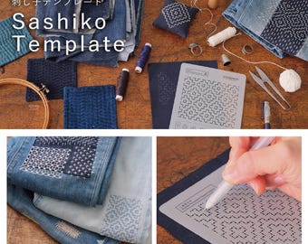 May include: A grey plastic Sashiko template with geometric cutouts for embroidery, accompanied by various blue fabric swatches, spools of thread, a wooden embroidery hoop, metal thimbles, scissors, and denim fabric featuring intricate white stitched patterns.