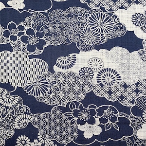 May include: Navy blue fabric with a white floral and geometric cloud pattern. The design features various flower shapes and intricate geometric patterns, creating a detailed and visually appealing textile.