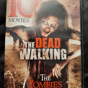 May include: DVD case for "The Dead Walking" with a zombie image. The cover features a zombie with long hair and an open mouth, with the title in large, bold letters. The text "The Zombies Are Coming" is also visible.