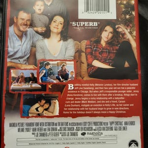 May include: DVD case for the movie "Happy Christmas" featuring Anna Kendrick. The cover shows a family portrait and a woman in a plaid shirt. The back includes a plot summary and cast credits.