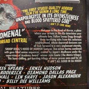 May include: A DVD case with a red and black design, featuring text that reads "Snoop Dogg's Hood of Horror." The case includes quotes and a list of special features, with a barcode at the top.