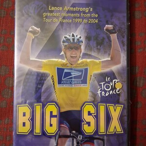 May include: Collector's Edition DVD featuring Lance Armstrong's greatest moments from the Tour de France, 1999-2004. The cover displays a photo of Armstrong in a yellow jersey, with the text "BIG SIX" in large yellow letters.