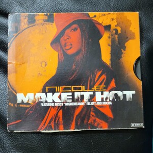 May include: CD single for Nicole's song "Make It Hot" featuring Missy "Misdemeanor" Elliott and Mocha. The cover art features a woman in an orange hat and jacket against an orange and black background.