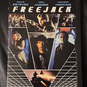 May include: DVD case for the film "Freejack" featuring Emilio Estevez, Mick Jagger, and Anthony Hopkins. The cover has a black background with images of the actors and the film's title in white. The DVD logo is in the lower left corner.