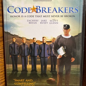 Puede incluir: Carátula de DVD para la película "Codebreakers" protagonizada por Zachery Bryan, Jake Busey y Scott Glenn. La portada muestra a un grupo de hombres con uniformes militares de pie en un campo de fútbol. El texto "El honor es un código que nunca debe romperse." se muestra en la portada.