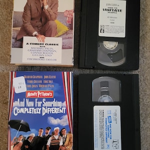 May include: Three VHS tapes, two with black cases and one with a white case. The tapes are for the comedy films "How to Irritate People" and "And Now For Something Completely Different".