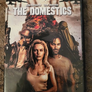 May include: DVD cover for the movie "The Domestics" starring Kate Bosworth and Tyler Hoechlin. The cover features a dark, apocalyptic scene with a couple standing in front of a burning building. The tagline reads "Good people didn't survive... they did."