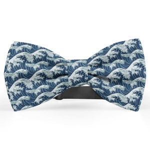 May include: A blue bow tie with a white and blue wave pattern.