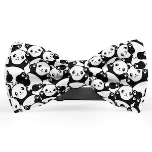 May include: A black and white bow tie featuring a pattern of panda bears. The pandas are all facing forward and have black eyes, pink cheeks, and white fur.