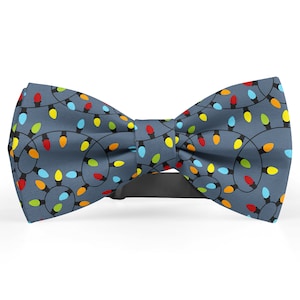 May include: A blue bow tie with a pattern of colorful Christmas lights.