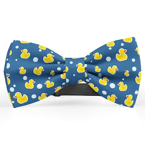 May include: A blue bow tie with a pattern of yellow rubber ducks and white bubbles.