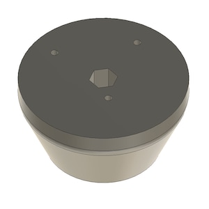 May include: A gray plastic base with a hexagonal hole in the center and two small round holes on the top. The base has a slightly rounded bottom.