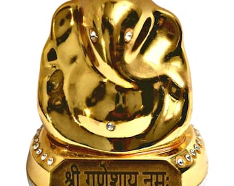 Op de afbeelding: Een gouden Ganesha-beeld met strasssteentjes op de basis en de inscriptie "Shri Ganeshay Namah".