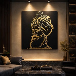 May include: A black square canvas print with a gold-coloured portrait of a man wearing a turban and a beard. The artwork is displayed in a modern living room with a dark sofa and a marble coffee table.