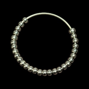 May include: Silver hoop earrings with a beaded design.