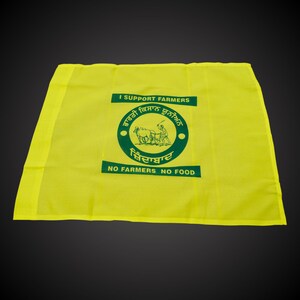 May include: A yellow flag with the text "I Support Farmers" and a green logo depicting a farmer plowing a field with an ox. The logo also includes the text "No Farmers No Food" in English and Punjabi.