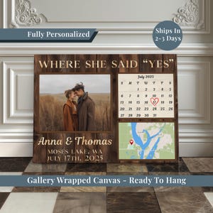 May include: A personalized wooden wall art piece with the text "WHERE SHE SAID 'YES'". It includes a photo, a calendar marked July 17th, 2025, and a map. The names "Anna & Thomas" and location are also displayed.