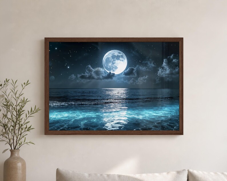 Moon Wall Art featuring a glowing full moon over the ocean, with silver light reflecting across dark blue water, soft clouds, scattered stars, and turquoise waves near the shore. This peaceful Ocean Wall Art brings a calming coastal theme to beach house decor, bathroom art, bedroom decoration, or maritime style wall decor.