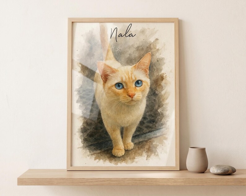 May include: A framed watercolor print of a cat named Nala. The cat has light orange fur and striking blue eyes. The artwork is set against a soft, textured background, with the cat's name written in cursive at the top.