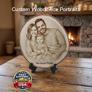 May include: A custom wood slice portrait featuring a family of three, engraved on a circular wooden slab. The text "Custom Wood Slice Portraits" is at the top. The family name "The Carson Family" is engraved at the bottom. The portrait is displayed on a wooden table.