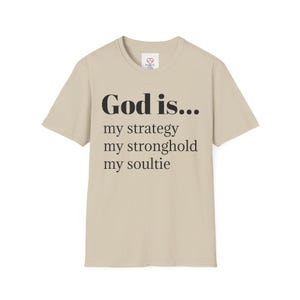May include: A beige t-shirt with black text that reads "God is... my strategy my stronghold my soultie"