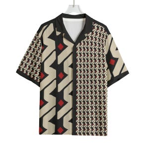 May include: Short-sleeved button-down shirt with a geometric pattern. The shirt features a black collar and trim, with a cream, black, and red design. The shirt is hanging on a white hanger.