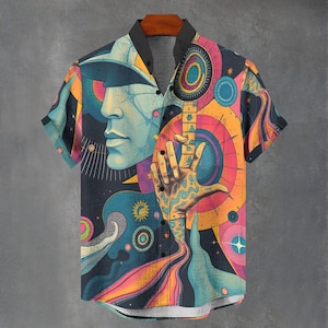May include: A short-sleeved button-up shirt with a colourful abstract print featuring a face, a hand, and a guitar. The print includes a variety of colours, including blue, green, yellow, orange, pink, and purple.