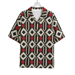 May include: Short-sleeved button-down shirt with a geometric pattern. The shirt features a black background with diamond shapes in red, white, and tan. The shirt is hanging on a white hanger.
