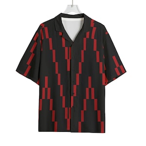 May include: Black button-down shirt with a red geometric pattern. The short-sleeved shirt has a camp collar and a white inner lining. The red pattern is a series of vertical and horizontal rectangles.