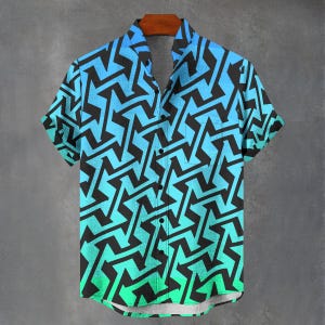 Puede incluir: Camisa de manga corta con un patrón geométrico negro sobre un fondo degradado azul y verde. La camisa está colgada en una percha de madera, mostrando su diseño y estilo.