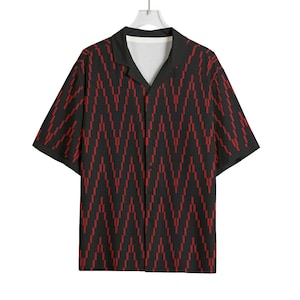 May include: Black button-down shirt with a red zigzag pattern. The short-sleeved shirt has a camp collar and a white inner lining. The shirt is hanging from a white hanger against a white background.