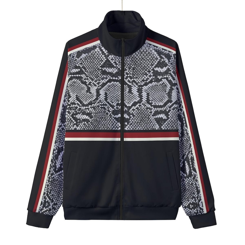May include: A black track jacket featuring a grey and black snakeskin pattern on the upper chest and sleeves. The jacket includes a full-length front zip, a high collar, and vertical stripes in red, white, and black along the outer sleeves.