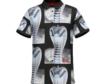 Peut inclure: Chemise boutonnée à manches courtes noire avec un motif répété de cobra blanc avec un logo "K.C." rouge dans le coin inférieur droit.