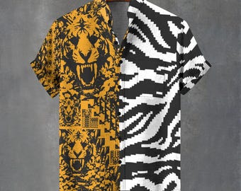 May include: Short-sleeved button-up shirt with a split design. One side features a black tiger face pattern on a yellow background, the other side has a black and white zebra stripe pattern. The shirt is hanging on a wooden hanger.