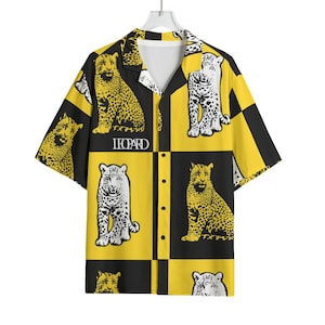 May include: Short-sleeved button-up shirt with a repeating leopard print in yellow and black. The shirt features a collared neckline and the word "LEOPARD" printed on the front.