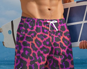 May include: Leopard print swim trunks in shades of purple, black, and orange. The shorts have a drawstring waist and the word "Leopard" is printed on the front. The trunks are made of a lightweight material.