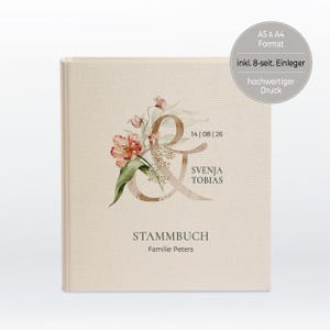 Könnte beinhalten: Ein beiges Buch mit einem Aquarell-Blumendesign und dem Ampersand-Symbol. Der Text "14 | 08 | 26" ist über dem Text "SVENJA TOBIAS" gedruckt. Der Text "STAMMBUCH" ist unter dem Text "Familie Peters" gedruckt.