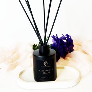 May include: Black diffuser bottle with black reeds and a gold label that reads "Nuetta Home Scents Patchouli & Resins Reed Diffuser - 100 ml - Handmade in Australia".