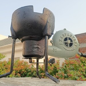 May include: A black cast iron forge with a stand and a green hand-crank bellows with the text "AZILD FACTORY 31" on it.