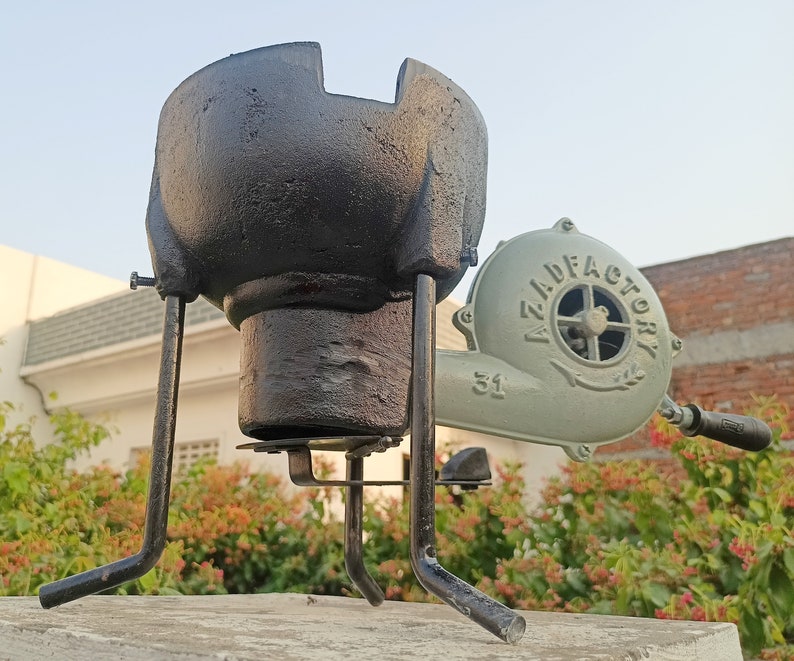 May include: A black cast iron forge with a stand and a green hand-crank bellows with the text "AZILD FACTORY 31" on it.