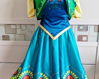 May include: A teal and blue costume dress with a yellow bodice and green vest. The dress features a sunflower pattern on the skirt. The vest is green with yellow and black accents. A costume for cosplay or dress-up.