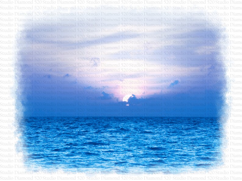 May include: A vibrant sunset over a calm blue ocean. The sky is a mix of pink, purple, and blue, with fluffy white clouds. The sun is setting behind the clouds, casting a warm glow on the water.