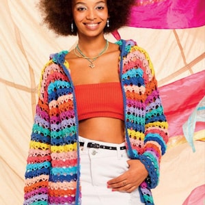 May include: A colourful striped crochet cardigan with a hood. The cardigan is made with a variety of bright colours, including pink, blue, yellow, and green. The model is wearing the cardigan over a red crop top and white denim skirt.