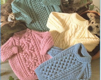 May include: Four knitted sweaters in different colors and patterns. The sweaters are light blue, pink, cream, and green. The sweaters are laid out on a tiled surface.